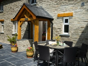 Front of Towy Cottage with paved patio, table and chairs