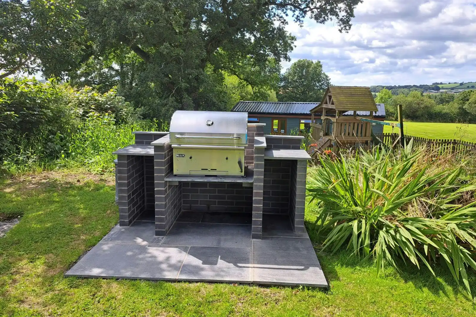 Communal charcoal BBQ and children's play area