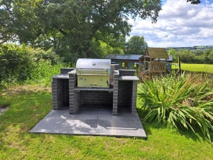 Communal charcoal BBQ and children's play area