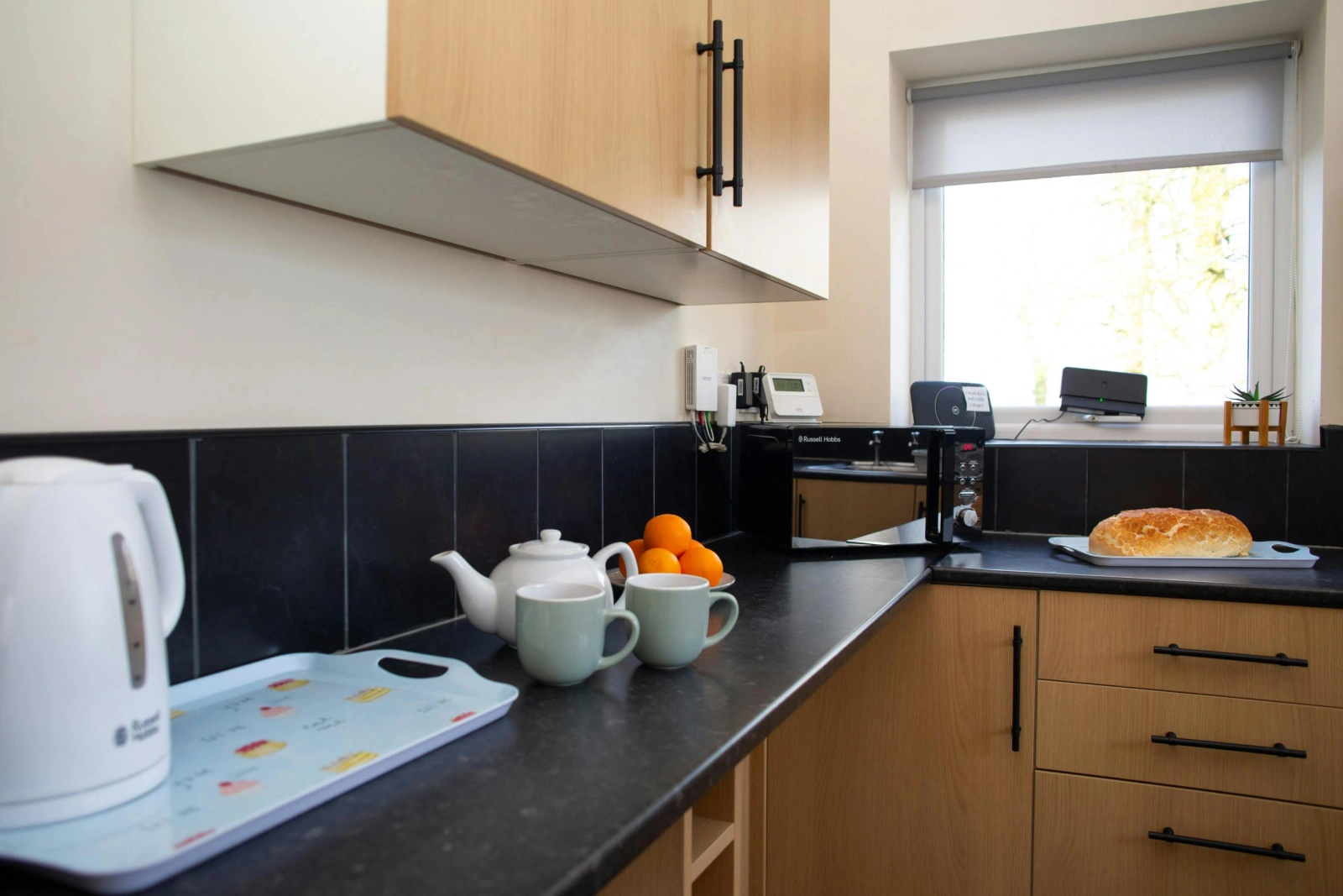 Kitchen with kettle and microwave