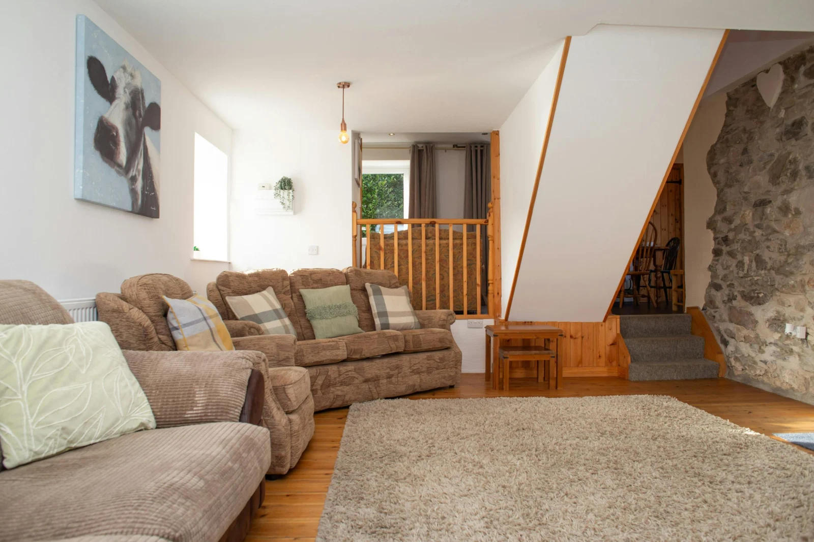 Lounge with stairs leading to the kitchen/dining room