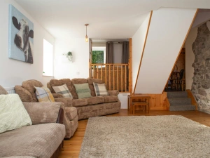 Lounge with stairs leading to the kitchen/dining room