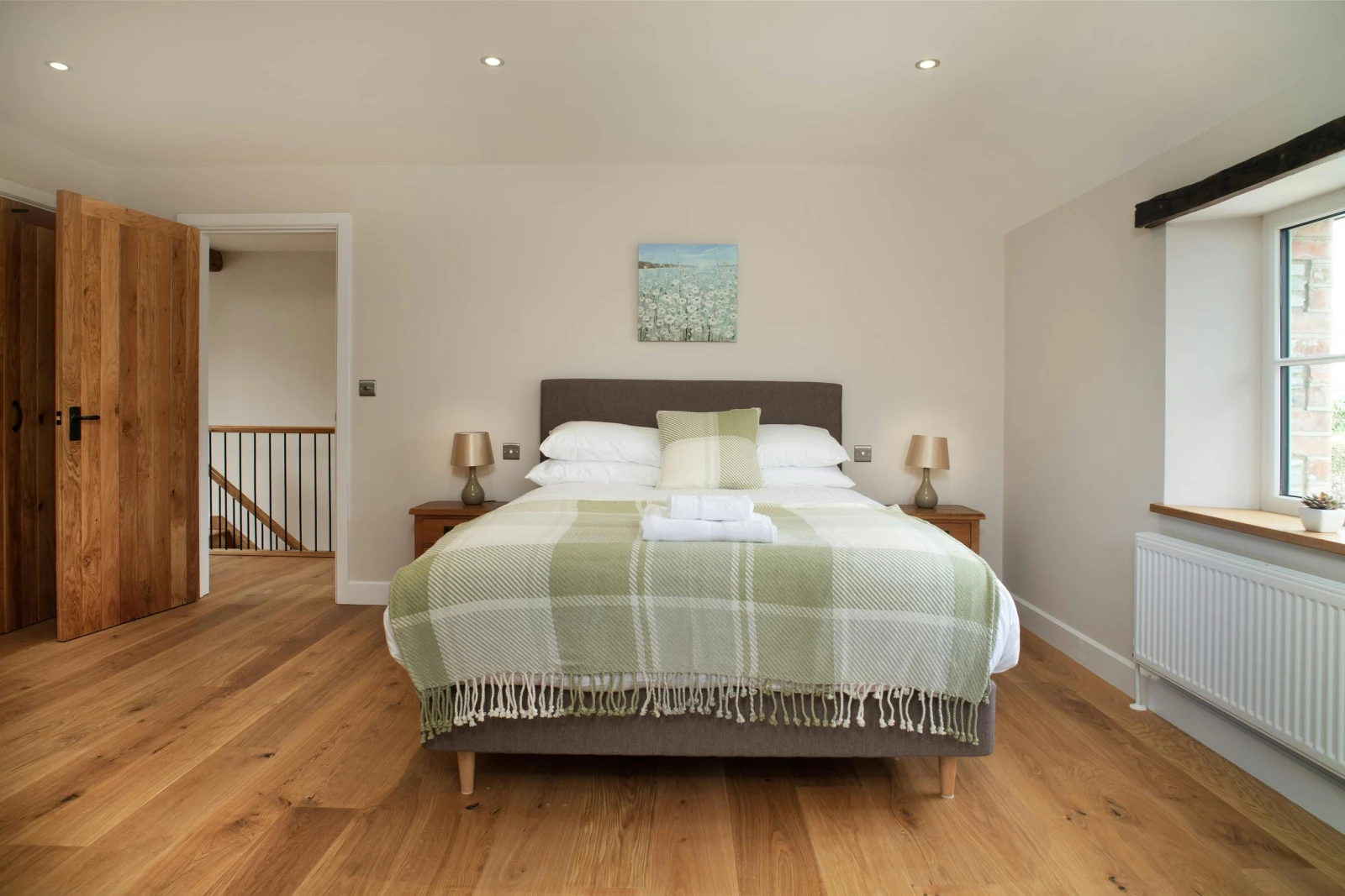 Bedroom with bed, bedside drawers and lamps