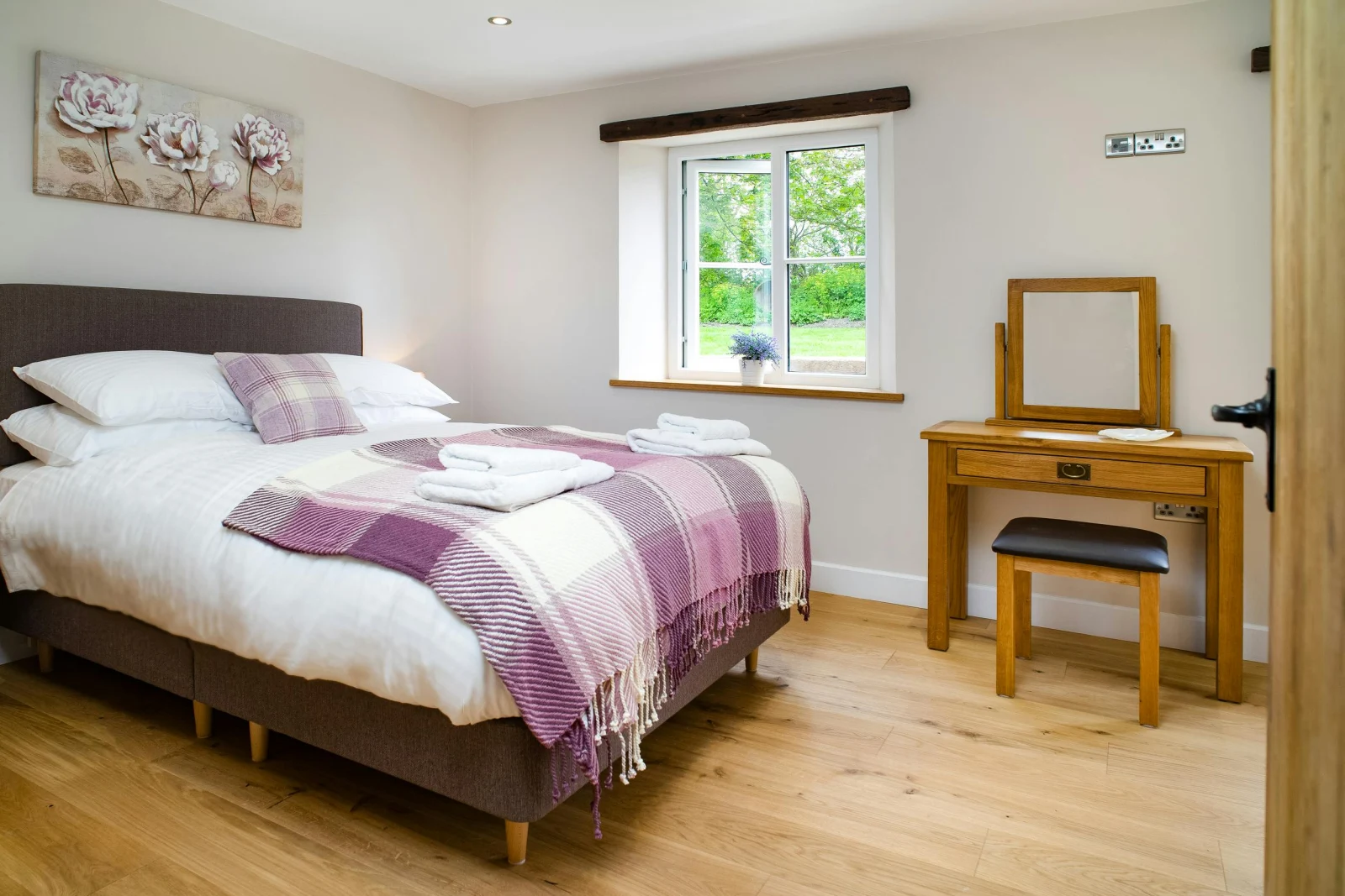 Bedroom with bed, dressing table, stool and mirror