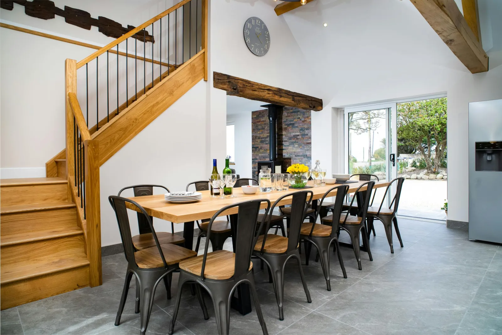 Dining area with table and ten chairs, patio doors to garden