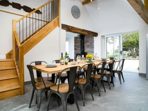 Dining area with table and ten chairs, patio doors to garden