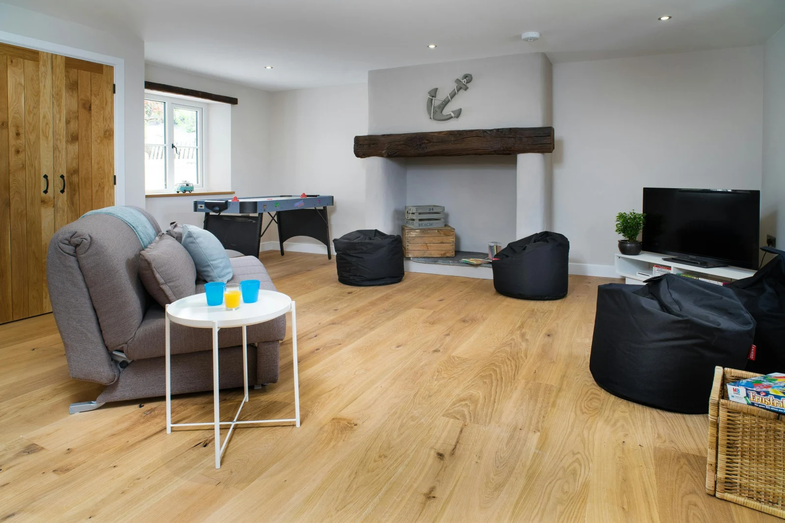 Games room with fireplace, beanbags, tv, sofa bed and coffee table