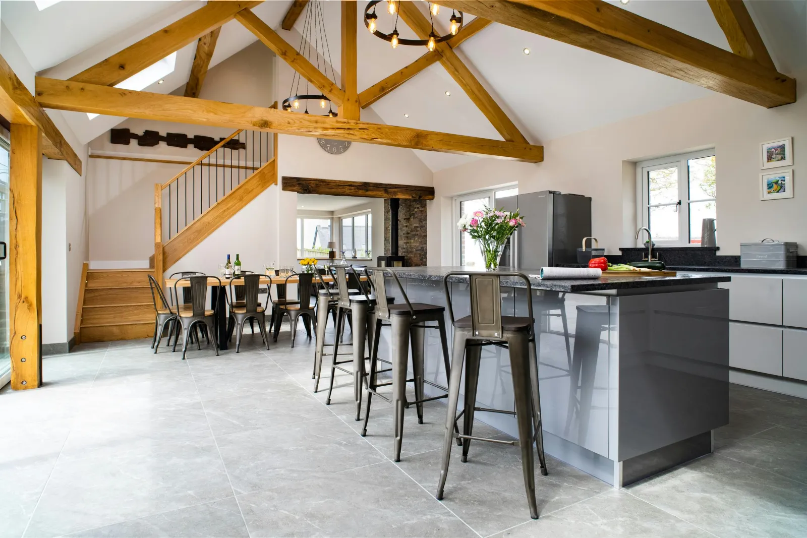Kitchen and dining area at Towyn Farmhouse with beamed ceiling and stairs to first floor