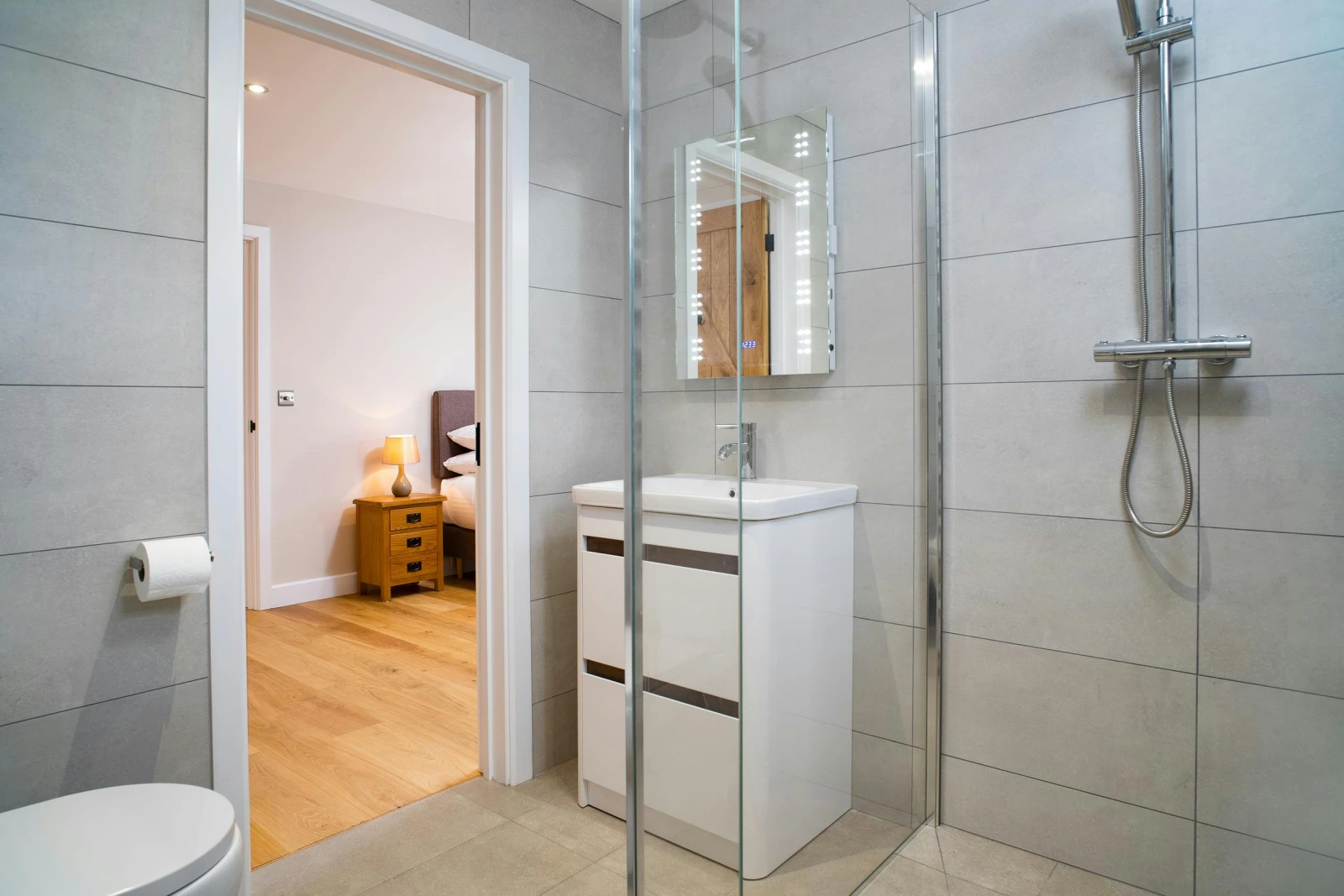 Shower room with vanity unit and basin, mirror, shower cubicle and toilet