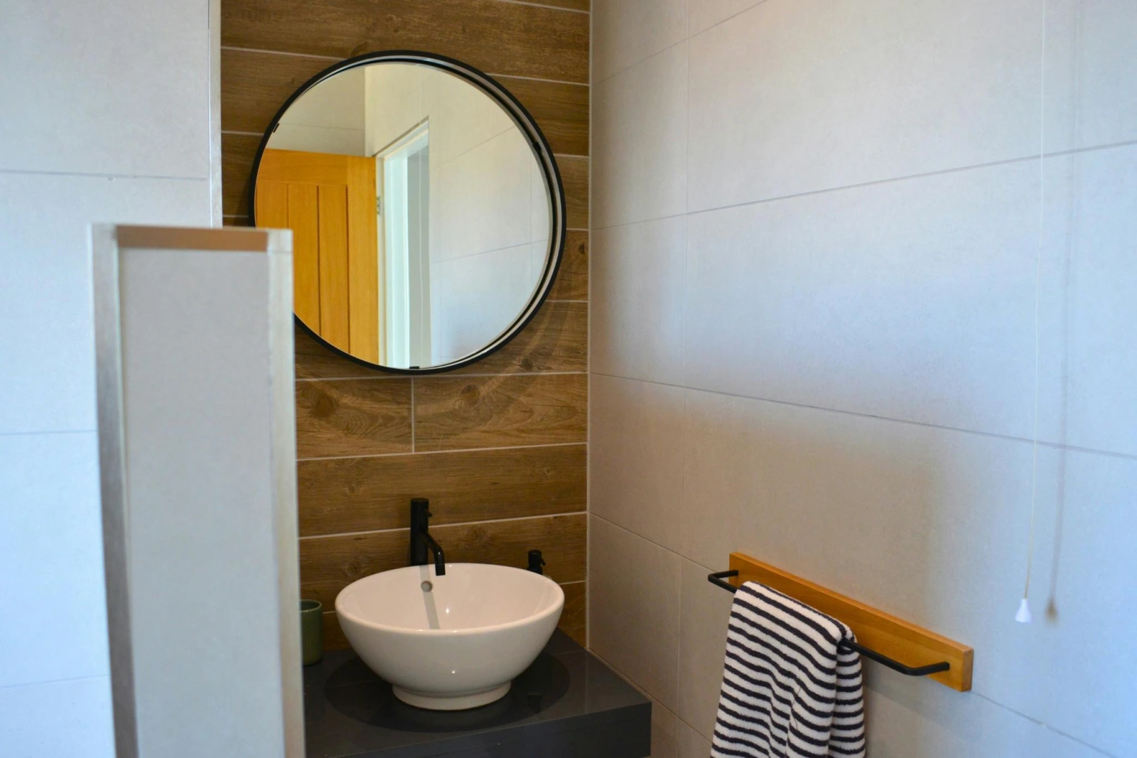 Wash basin with mirror above and towel rail