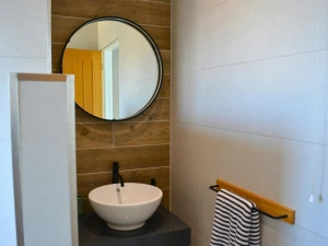 Wash basin with mirror above and towel rail