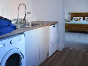 Utility room, washing machine, tumble dryer and sink