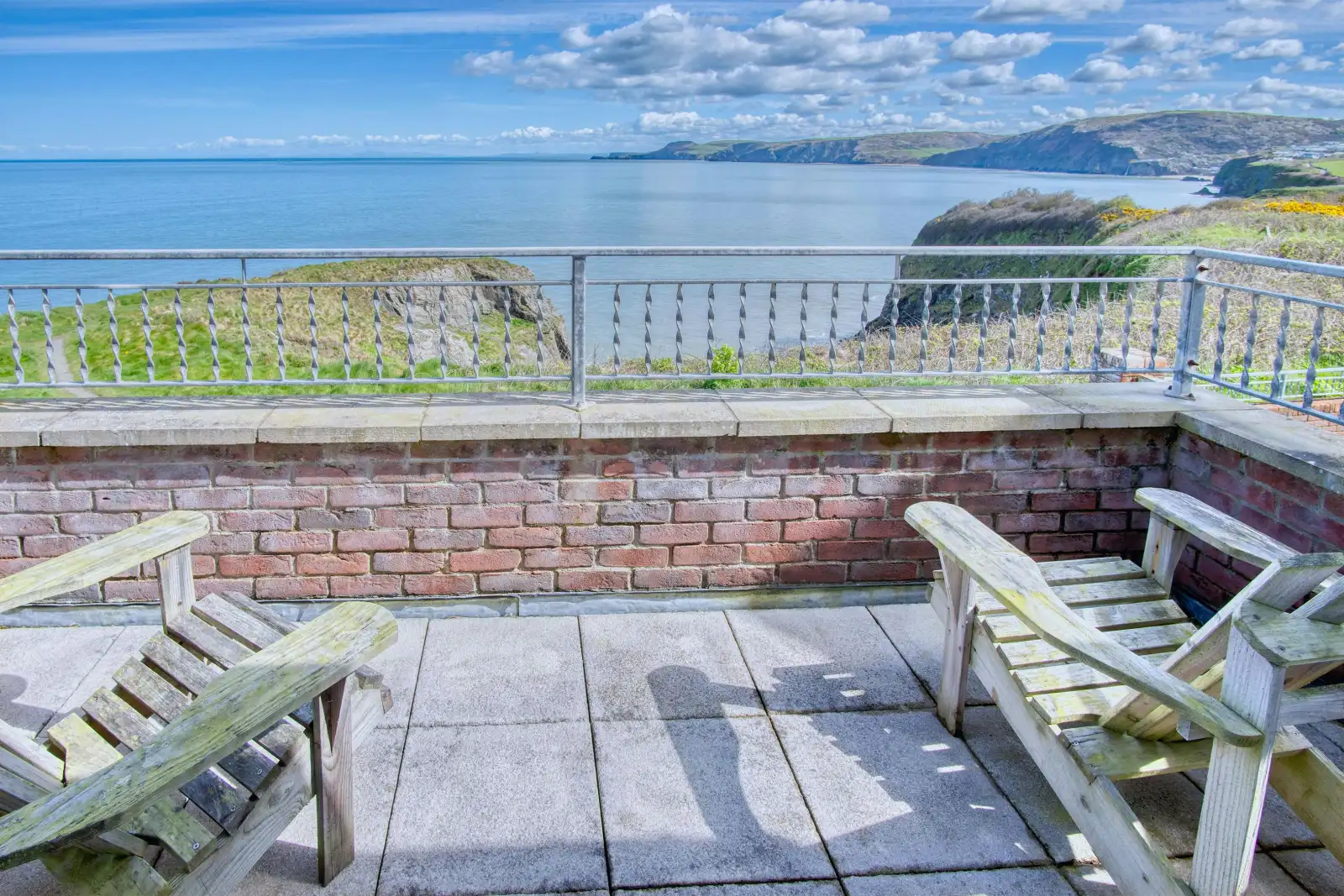 Balcony from master bedroom with 2 steamer seats, views along the coastline and to sea