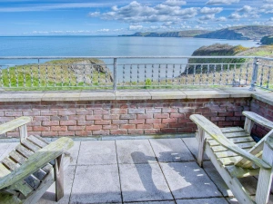 Balcony from master bedroom with 2 steamer seats, views along the coastline and to sea