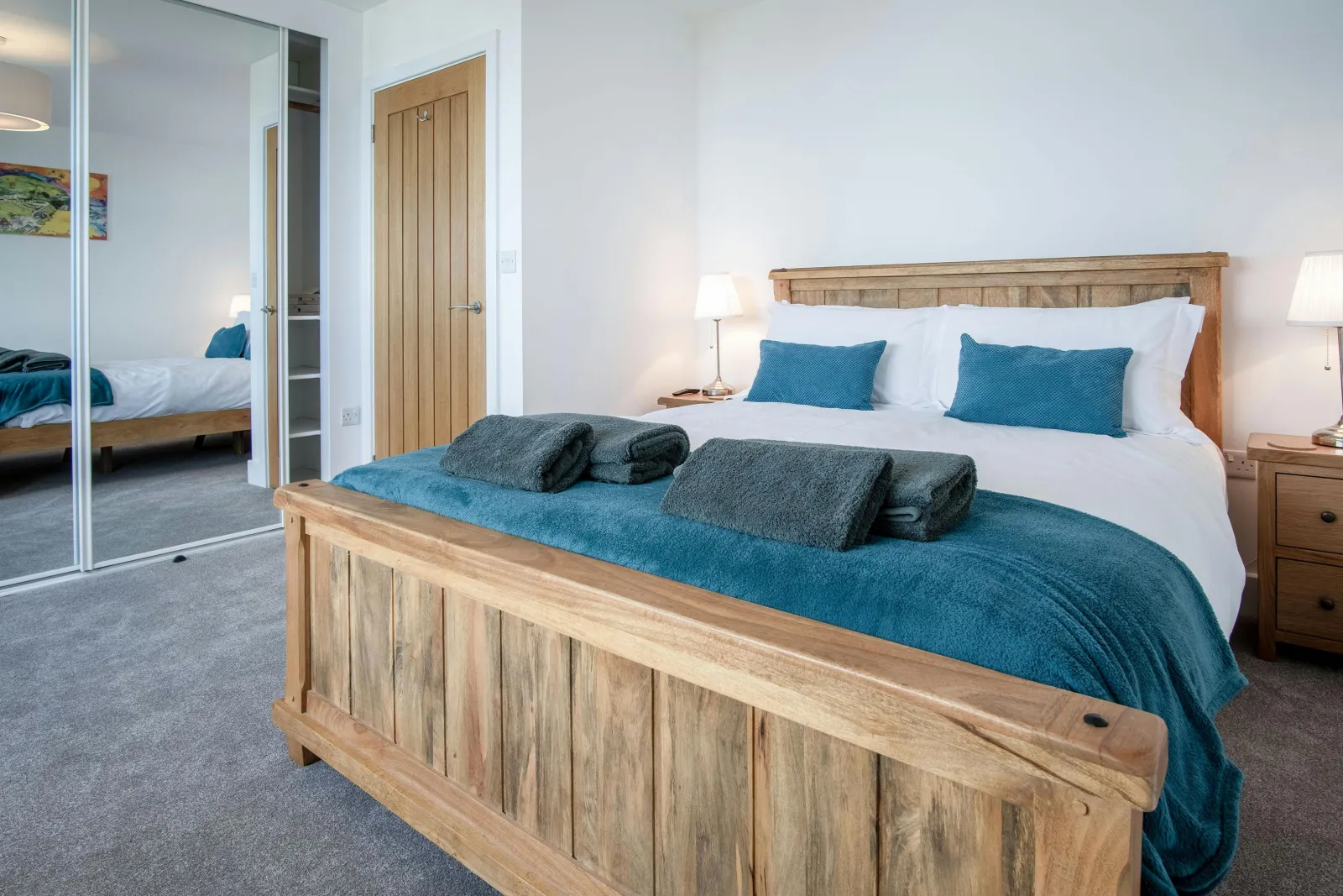 King size bedroom, towels, bedside cabinets with lamps and fitted wardrobes