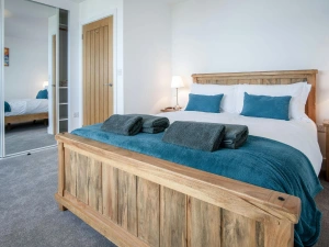 King size bedroom, towels, bedside cabinets with lamps and fitted wardrobes