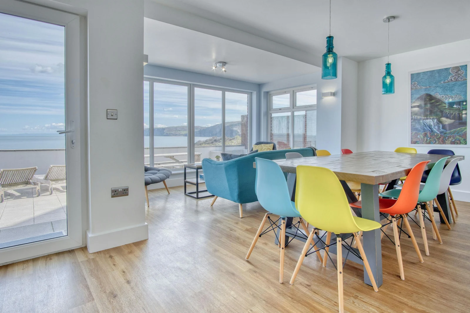 Dining area, table and chairs, comfy seating and views to the patio and sea
