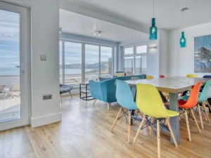 Dining area, table and chairs, comfy seating and views to the patio and sea