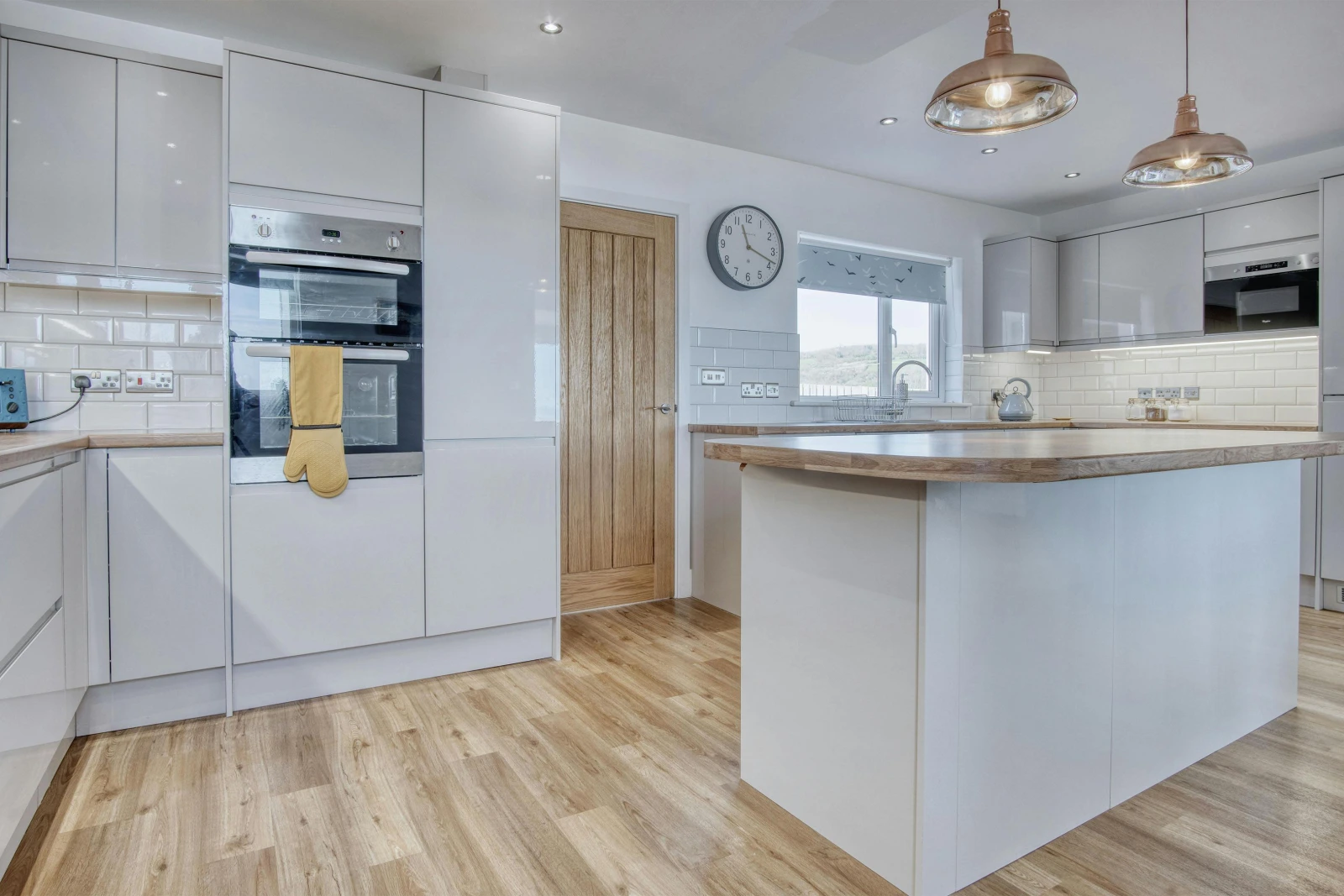 Island in the kitchen with work surfaces, kettle, microwave, built-in oven