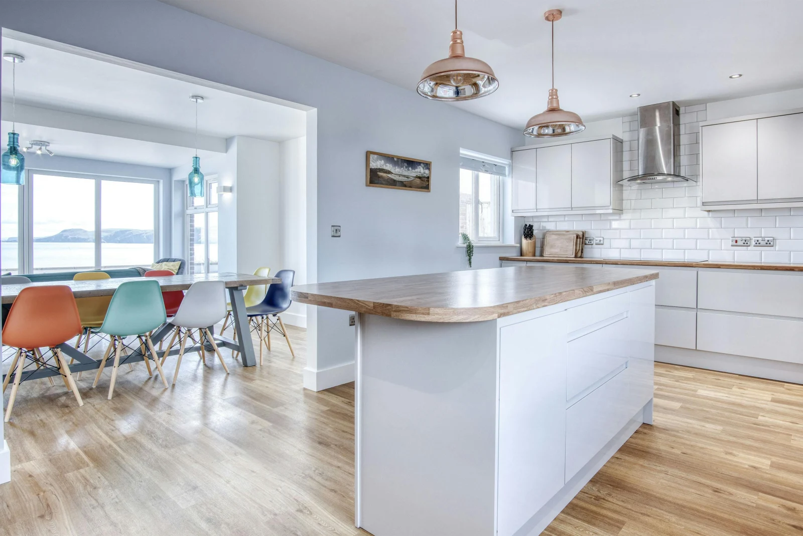 Island in the middle of the kitchen, dining table and chairs