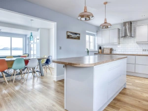 Island in the middle of the kitchen, dining table and chairs