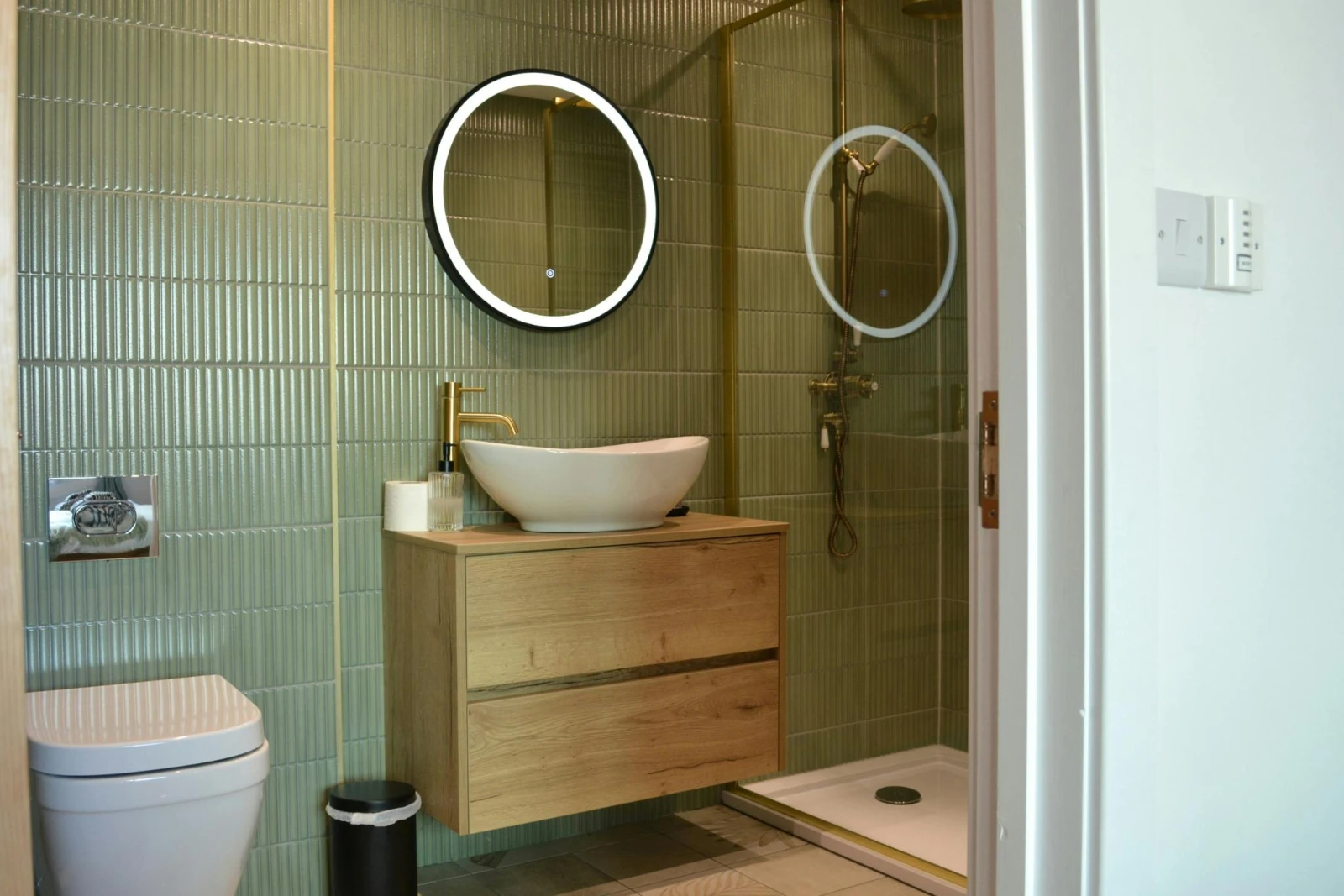 WC, wash basin with mirror above and shower cubicle