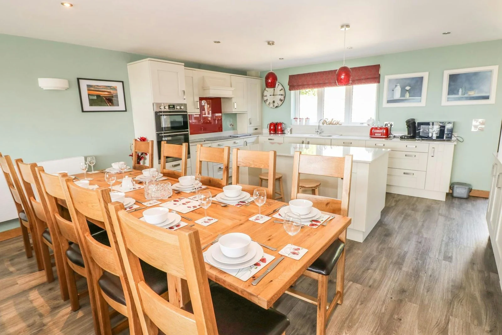 Kitchen/dining area in Harmon Vale with fitted units, table and 10 chairs, built-in oven, hob, microwave, kettle and toaster