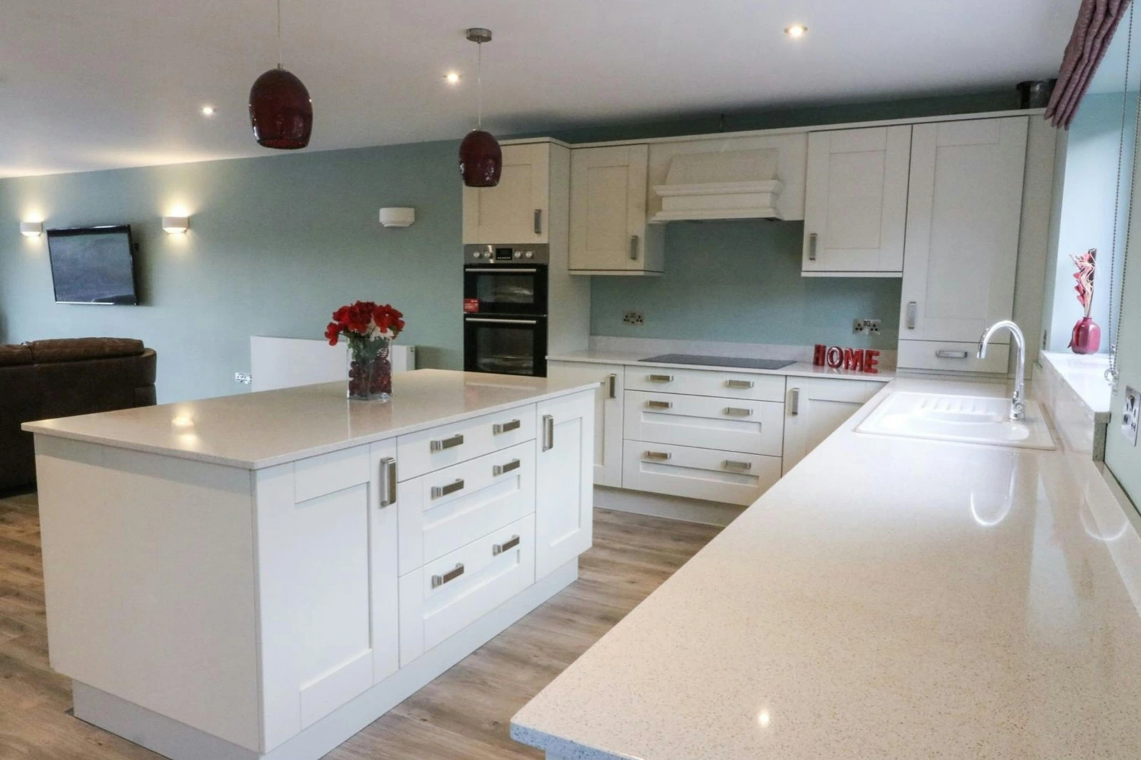 Fitted kitchen with built-in oven and hob