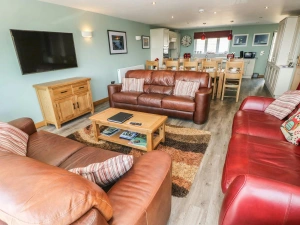 Sofas, wall mounted TV, dining kitchen to the rear of the room in Harmon Vale