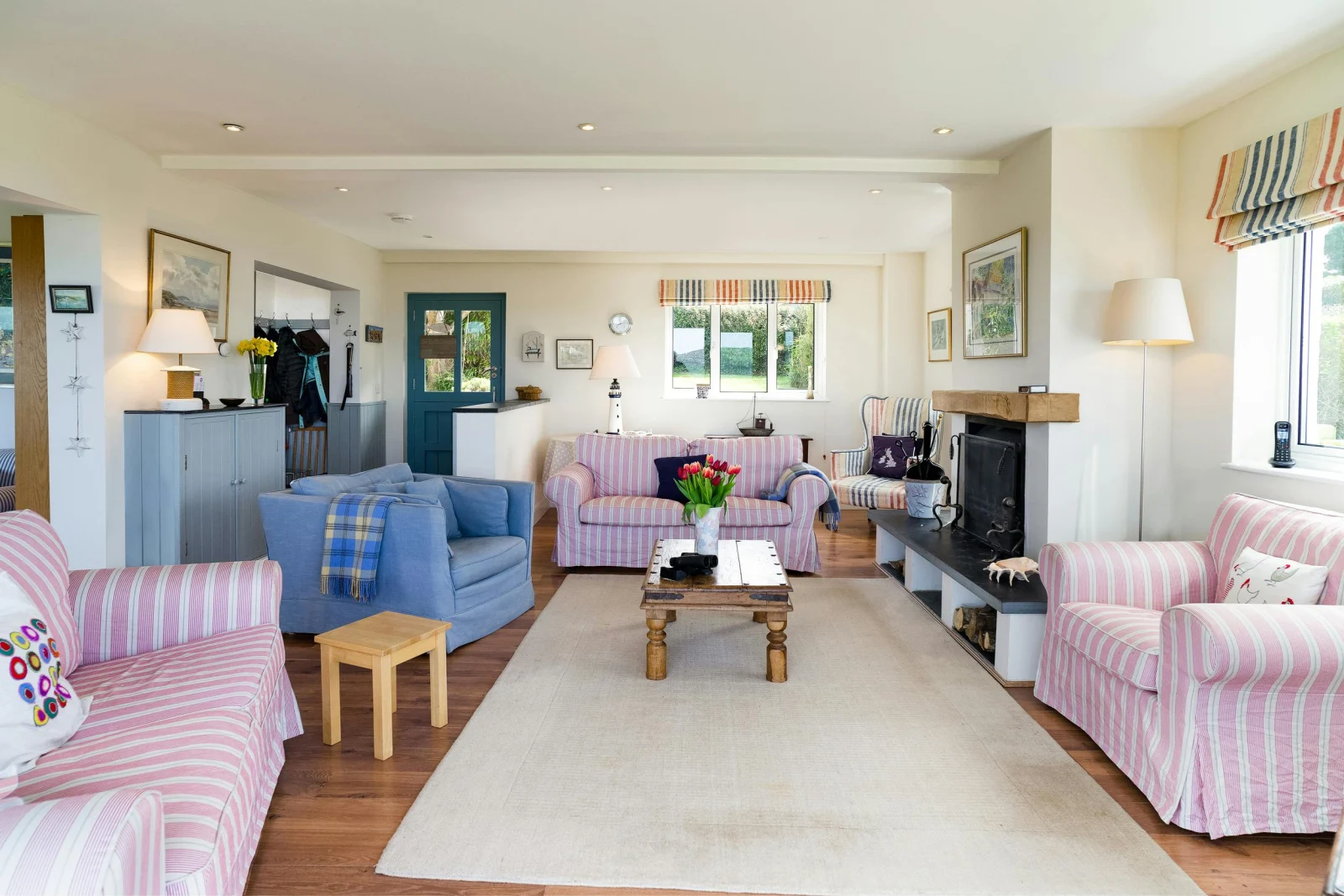 Living area with sofas, armchairs, fireplace and coffee table