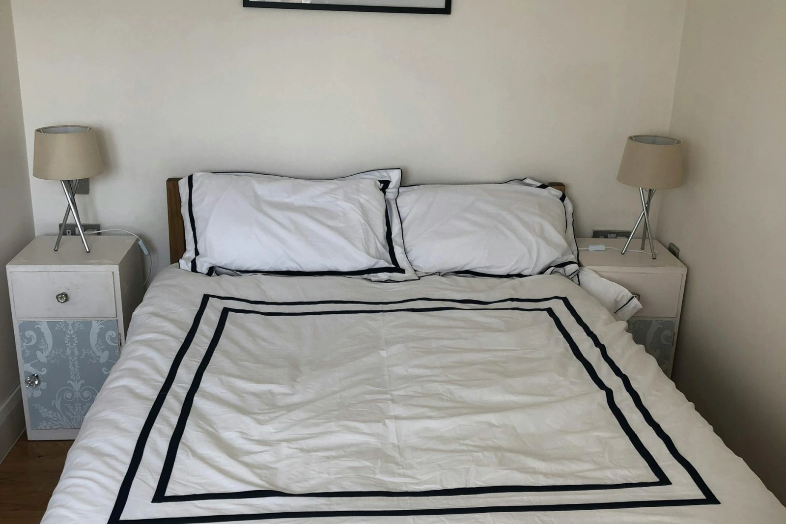 Double bed, bedside cabinets and lamps, picture above bed