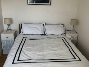 Double bed, bedside cabinets and lamps, picture above bed