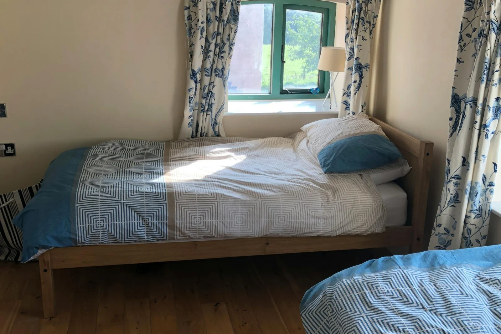 Bedroom with two beds and two low windows