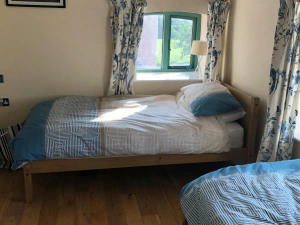 Bedroom with two beds and two low windows