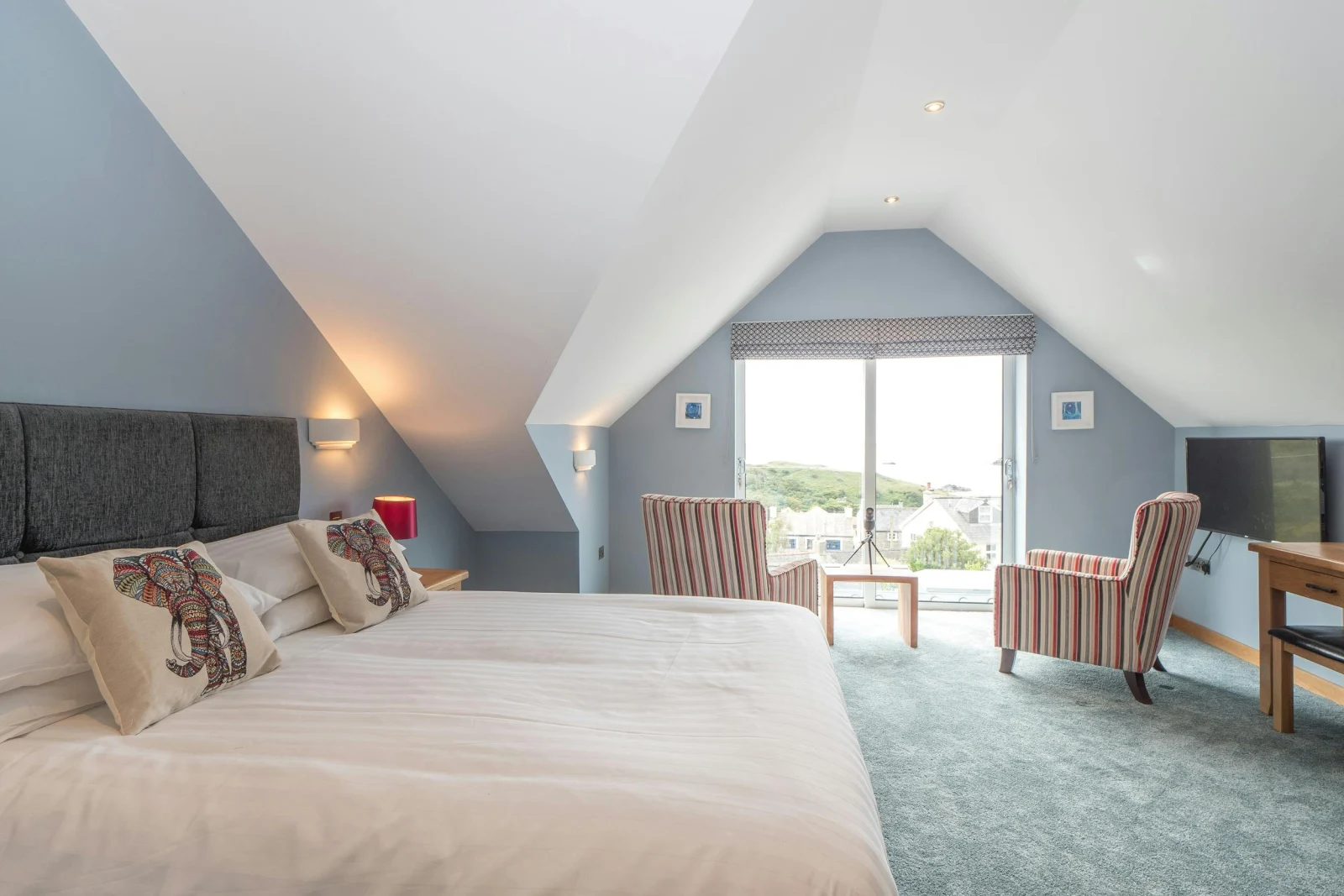 Large bed, armchairs and picture window