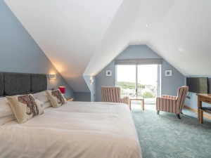 Large bed, armchairs and picture window