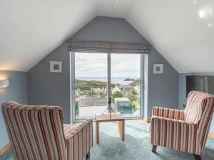 Large window with 2 armchairs and coffee table