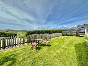 enclosed garden with outdoor table and chairs, blue skies
