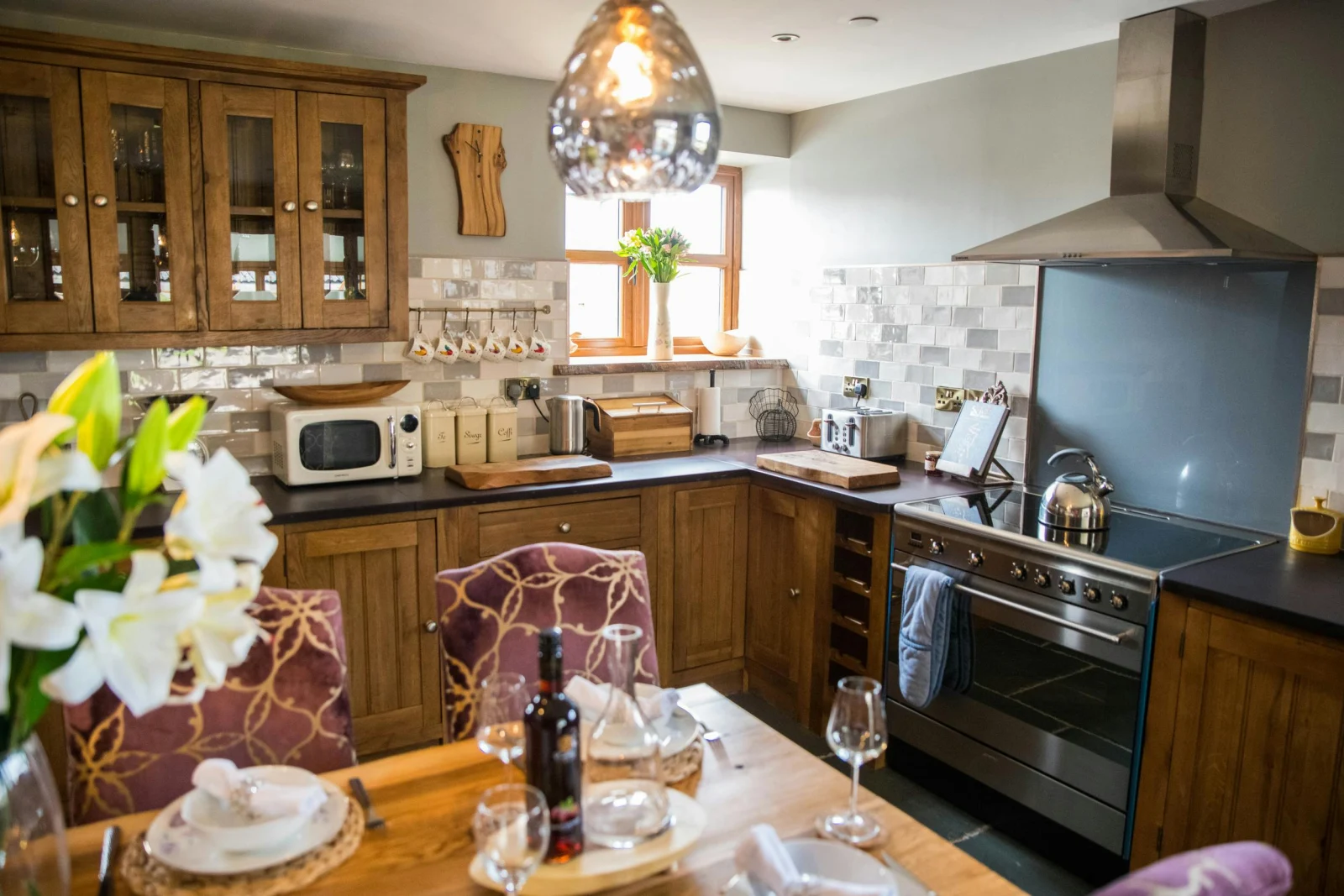 Electric range, microwave, wall and floor cabinets and kitchen table