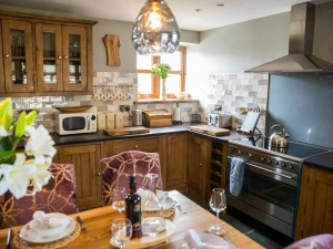 Electric range, microwave, wall and floor cabinets and kitchen table