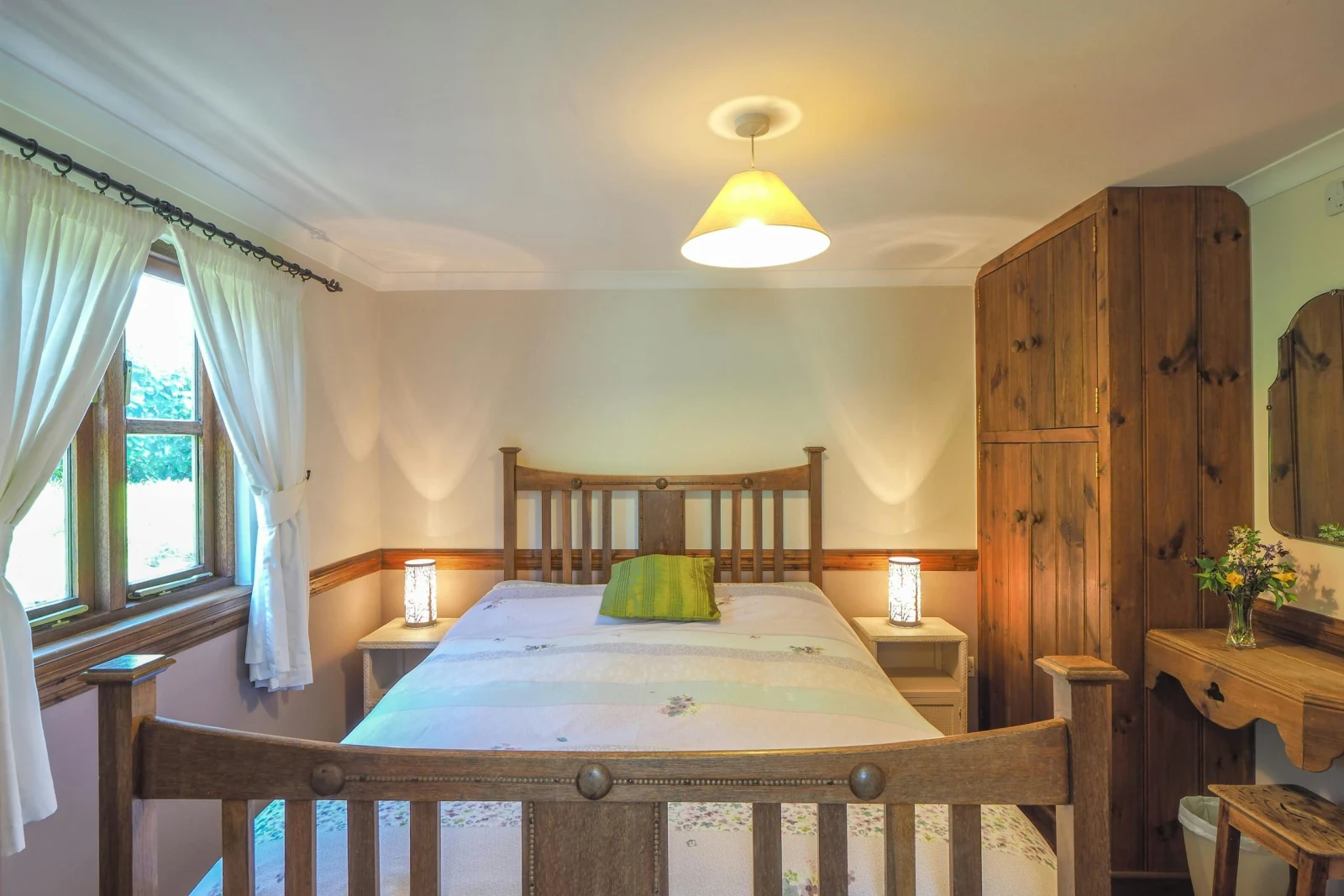 Bedroom with double bed, wardrobe, bedside tables and reading lights