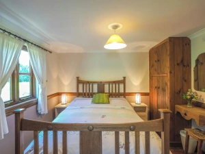 Bedroom with double bed, wardrobe, bedside tables and reading lights