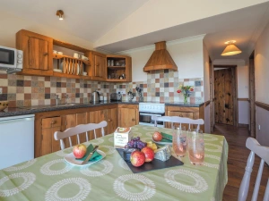 Kitchen and dining area, wooden kitchen units, cooker and cooker hood, dining table