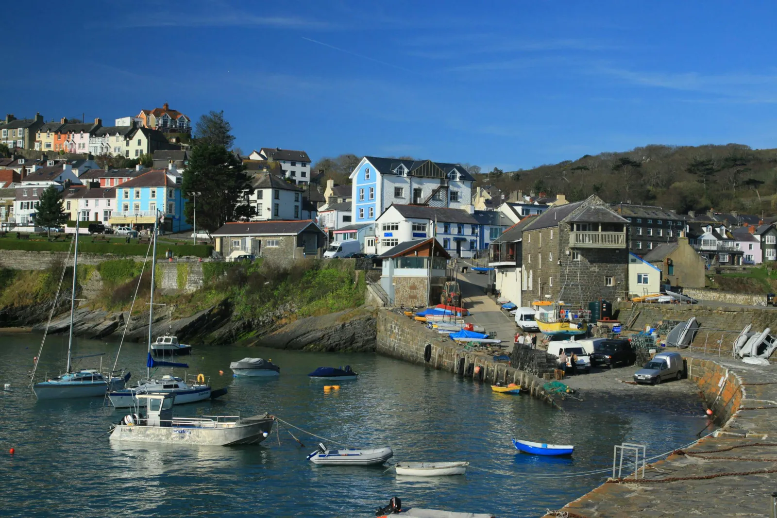 New Quay Harbour with boats on the sea, houses in the background