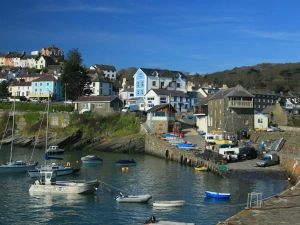 New Quay Harbour with boats on the sea, houses in the background