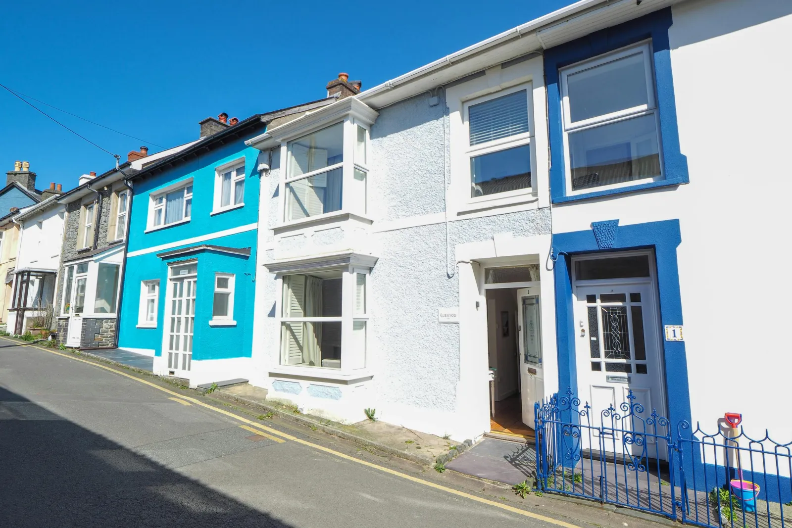 The outside of Glenydd with the front door open