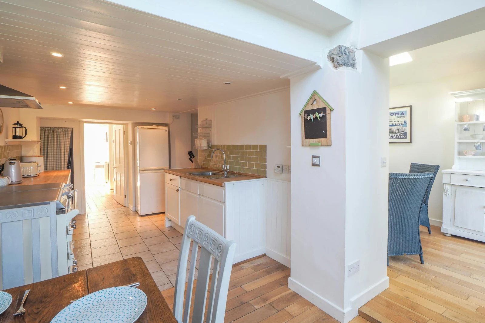 Kitchen with dining table and chairs in the foreground