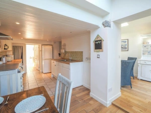 Kitchen with dining table and chairs in the foreground