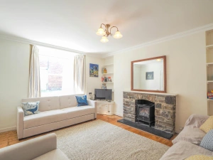 Sofas, fireplace and large mirror above, TV