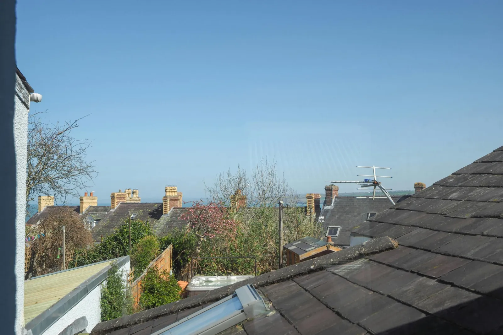 View out the window across the roofs to the sea